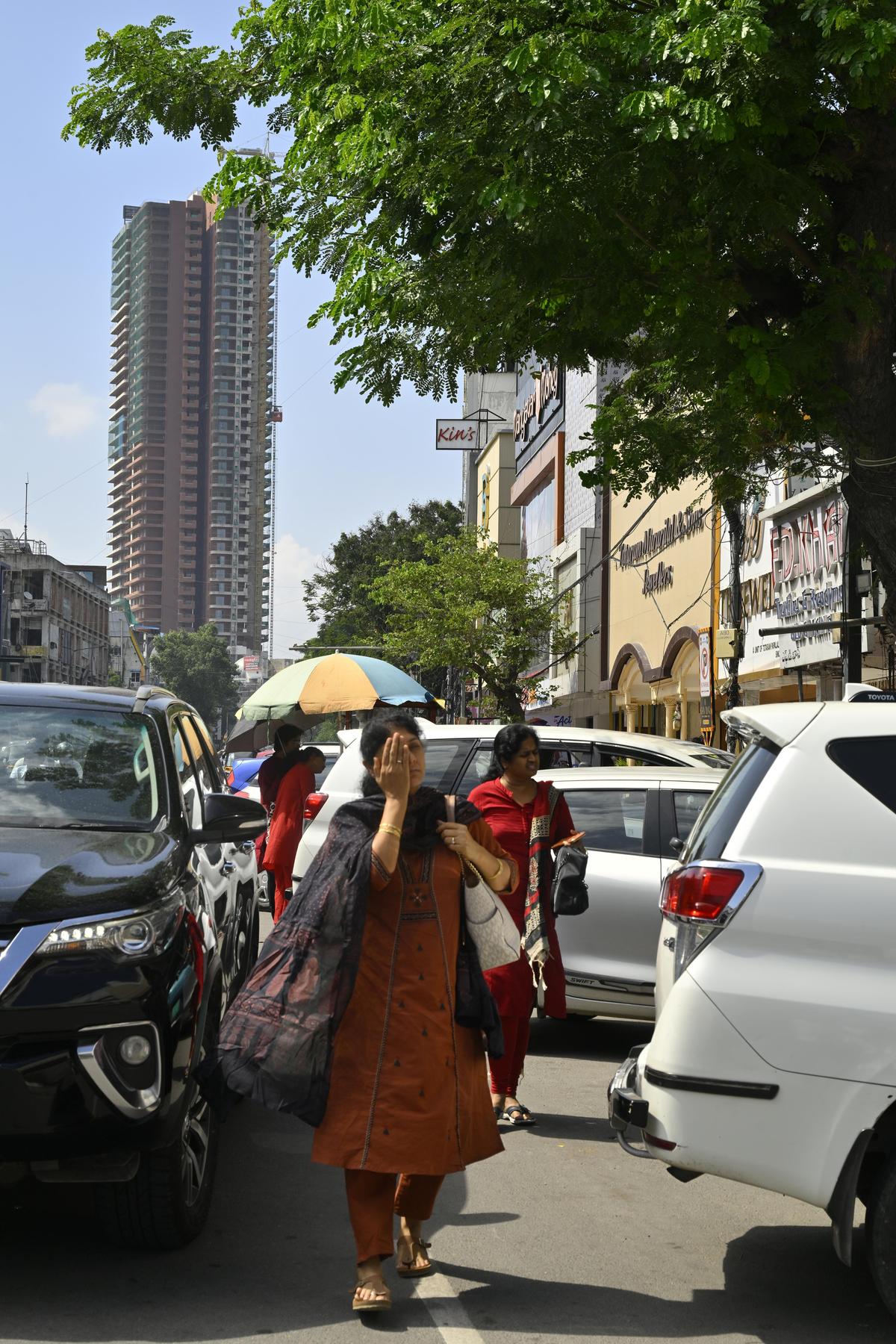 In the absence of footpaths, pedestrians make their way through the bustle of vehicular traffic in Abids, Hyderabad, on Thursday.